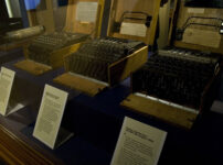 Three Enigma Machines on display in the Science Museum