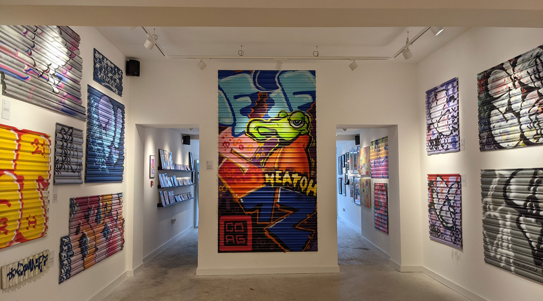 Graffiti covered shop shutters fills an art gallery