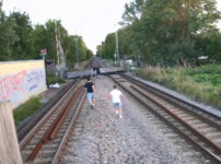 Risky Shortcuts: Passengers risk lives walking along railway tracks during station footbridge installation