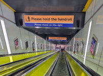 London’s largest escalator handrail holding signs?